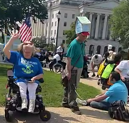 Activist with disabilities outside of US Capitol wearing house hats