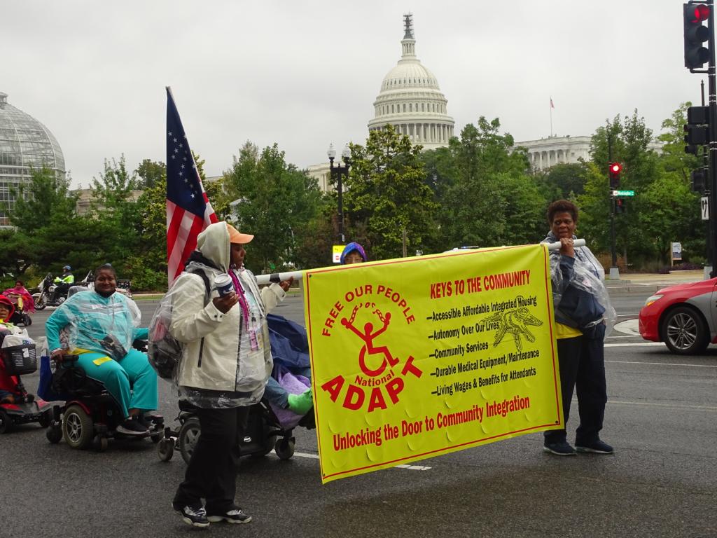 Protesters with banner marching in DC.