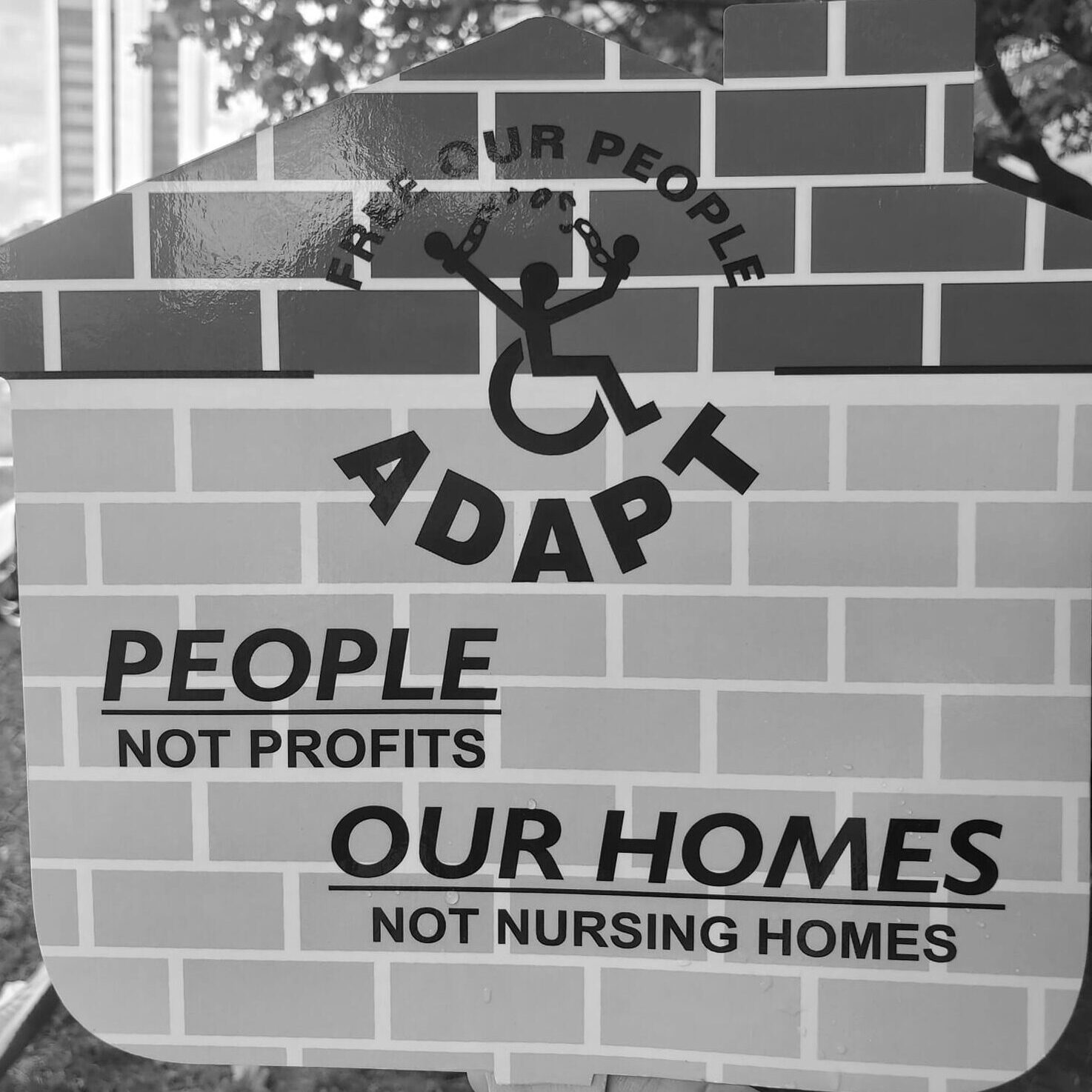 A picture of a sign with the National ADAPT logo.